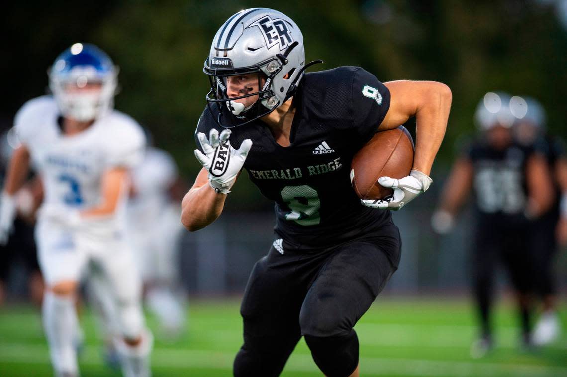 Emerald Ridge wide receiver Gio Kafentzis (8) runs with the ball after catching a pass from Emerald Ridge quarterback Jake Schakel (14) in the first quarter of a game against Curtis at Sparks Stadium in Puyallup, Wash. on Sept. 22, 2022. Emerald Ridge defeated Curtis 42-13.