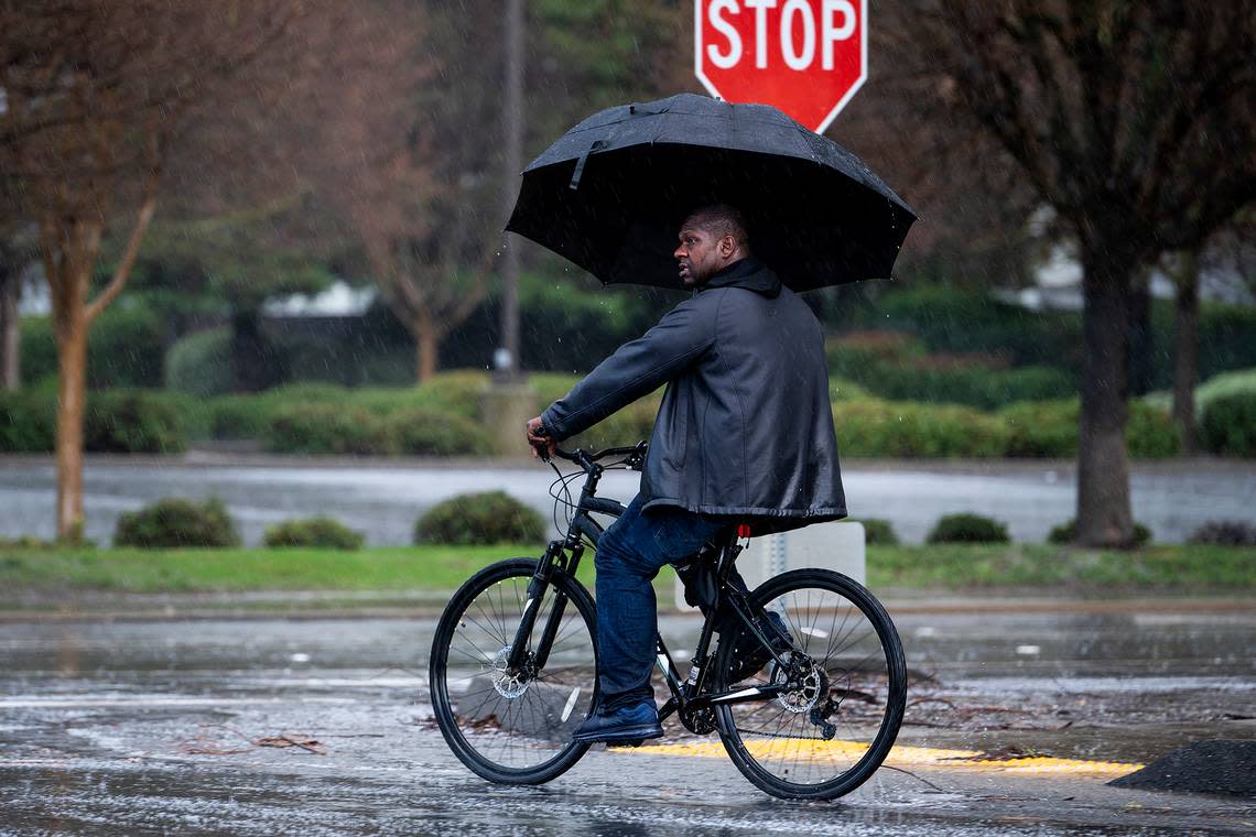 A bicyclist crosses M Street at Buena Vista Drive during a short rain and hail storm in Merced, Calif., on Monday, Jan. 16, 2023.