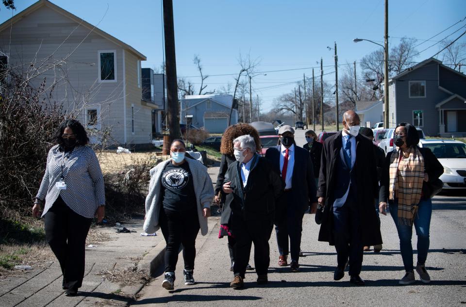 Mayor John Cooper along with Rep. Harold Love and Metro Council Member Brandon Taylor and others take a walking tour of tornado recovery efforts Wednesday, March 3, 2021 in Nashville, Tenn. A year ago tornado ripped through Middle Tennessee damaging many homes in North Nashville. 