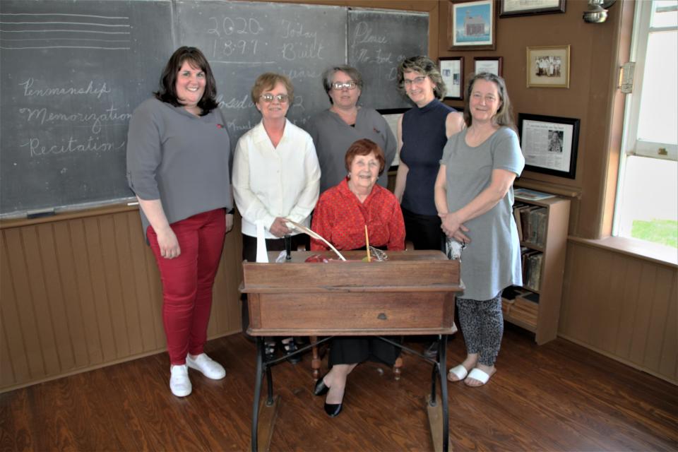 Marion County Historical Society officials conducted a grand-reopening ceremony on Thursday, May 12, 2022, at Linn School. Pictured from left to right are Brandi Wilson, executive director of the historical society; volunteer Carol Robinson; society administrative assistant Bobbie Hooper; society board president Diane Watson; and society educational curator Rebecca McKinney. Seated is volunteer Jan Augenstein.