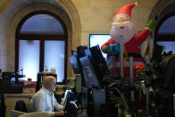 Christmas decorations are displayed as traders work on the floor at the New York Stock Exchange in New York, Monday, Nov. 28, 2022. (AP Photo/Seth Wenig)