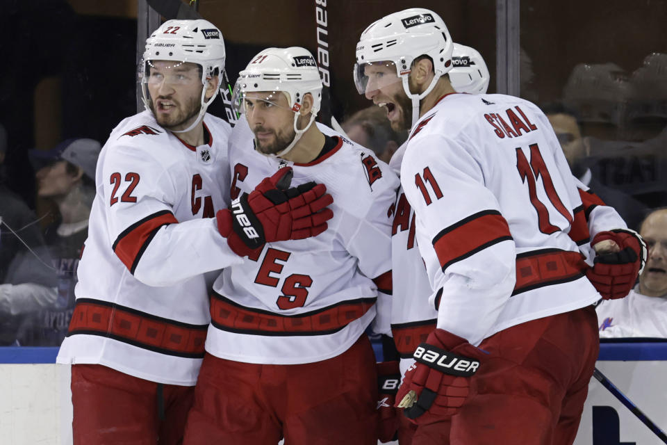 Carolina Hurricanes right wing Nino Niederreiter (21) is congratulated by teammates after scoring a goal against the New York Rangers during the second period of Game 3 of an NHL hockey Stanley Cup second-round playoff series, Sunday, May 22, 2022, in New York. (AP Photo/Adam Hunger)