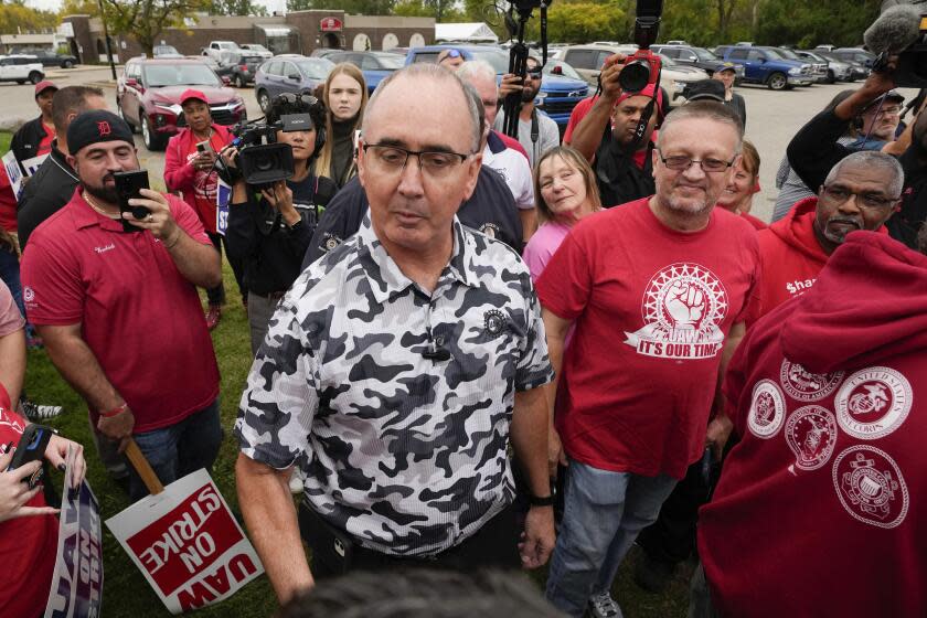 File - United Auto Workers President Shawn Fain talks with members picketing near a General Motors Assembly Plant in Delta Township, Mich., on Sept. 29, 2023. Fain is scheduled to update members today on bargaining with Detroit automakers as strikes against the companies head into their sixth week. (AP Photo/Paul Sancya, File)