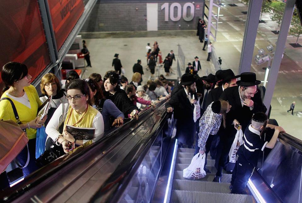 Men and women ride separate escalators to their designated seating sections as Orthodox Jews gather during a 2012 event to celebrate religious study in New Jersey. <a href="https://www.gettyimages.com/detail/news-photo/men-and-women-ride-separate-escalators-to-their-designated-news-photo/149661933?adppopup=true" rel="nofollow noopener" target="_blank" data-ylk="slk:Mario Tama/Getty Images;elm:context_link;itc:0;sec:content-canvas" class="link ">Mario Tama/Getty Images</a>