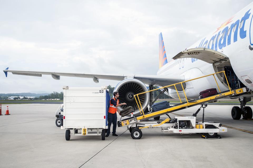 A worker loads bags onto an Allegiant Air jet at Asheville Regional Airport in this file photo.