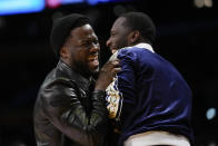 Comedian Kevin Hart, left, laughs with sports agent Rich Paul during the first half of an NBA basketball game between the Memphis Grizzlies and the Los Angeles Lakers in Los Angeles, Friday, Jan. 20, 2023. (AP Photo/Ashley Landis)