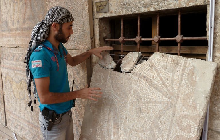 A Syrian rebel fighter inspects a mosaic at the Alma Arra museum in Maarat al-Numan in October