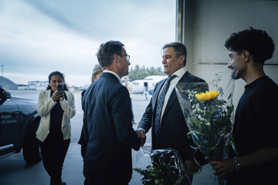 In this photo provided by the Swedish government, Saeed Azizi, right, is greeted by Prime Minister Ulf Kristersson at Arlanda airport in Stockholm, Sweden on Saturday, June 15, 2024, after being released from prison in Iran. (Tom Samuelsson/Swedish government/TT News Agency via AP)