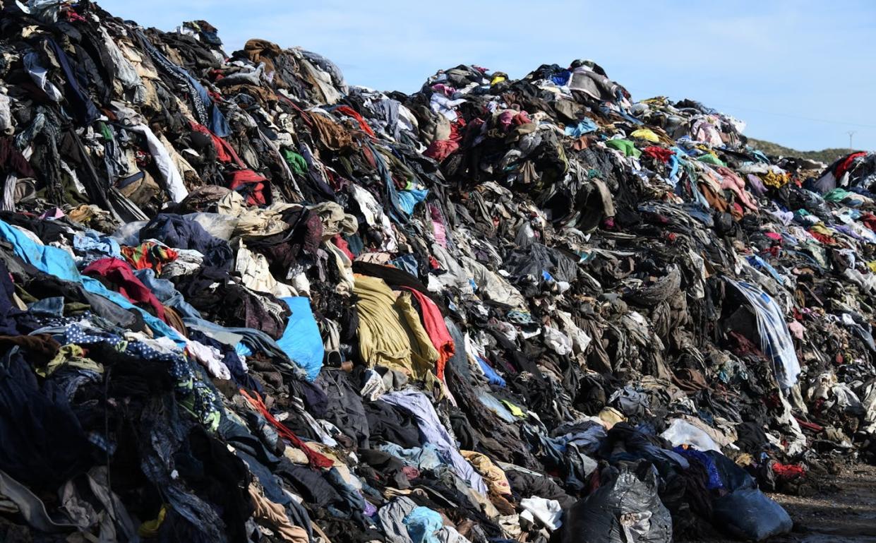 Making connections between consumer choices, marketing approaches and environmental impacts matters for our shared future. Clothes in a bin in Costa Blanca, Spain. (Shutterstock)