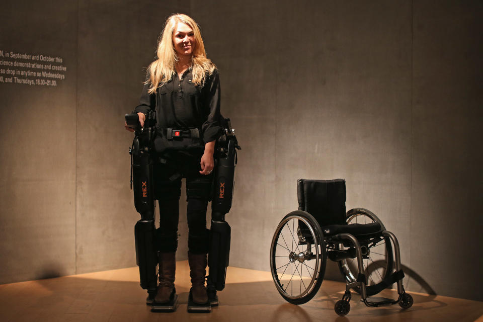 LONDON, ENGLAND - SEPTEMBER 19:  Sophie Morgan walks with the aid of 'Rex', a Robotic Exoskeleton at the Welcome Trust on September 19, 2012 in London, England. The system allows wheelchair users including fully paralysed people, to stand upright and walk independently. Sophie was paralysed from the breast bone down in 2003 following a car accident.  (Photo by Dan Kitwood/Getty Images)