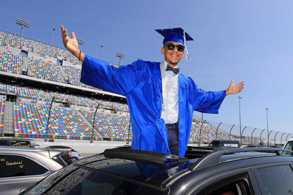 DAYTONA BEACH, FLORIDA - MAY 31:  Graduates of Matanzas High School receive their diplomas on the track in their cars at Daytona International Speedway on May 31, 2020 in Daytona Beach, Florida. (Photo by Sam Greenwood/Getty Images)