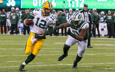 Green Bay Packers quarterback Aaron Rodgers (12) runs for a two point conversion during the second half of their game against the New York Jets at MetLife Stadium - Credit: USA TODAY