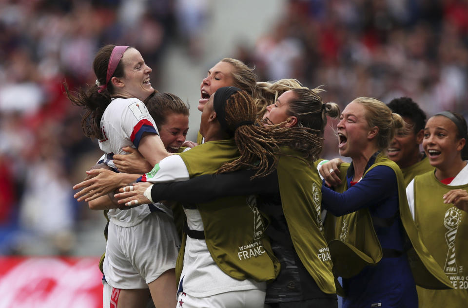 United States' Rose Lavelle, left, celebrates after scoring her side's second goal during the Women's World Cup final soccer match between US and The Netherlands at the Stade de Lyon in Decines, outside Lyon, France, Sunday, July 7, 2019. (AP Photo/Francisco Seco)