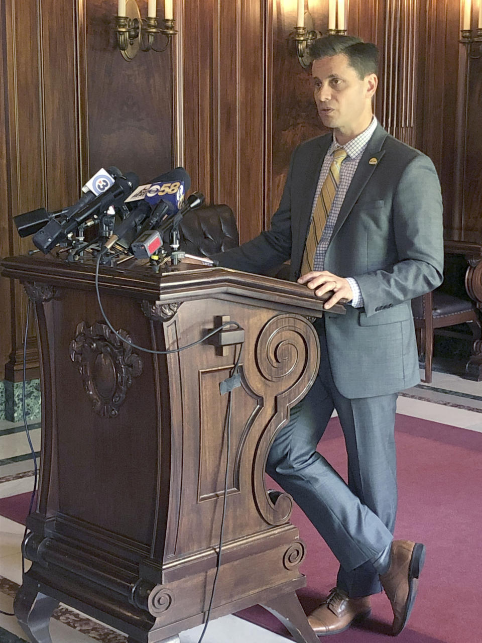 Republican Wisconsin state Sen. Chris Kapenga talks to reporters about his hobby of rebuilding Tesla vehicles during a news conference Wednesday, June 26, 2019, in Madison, Wisconsin. Kapenga says it has nothing to do with his support for the state budget that includes a provision that would allow the electric car manufacturer to sell its vehicles directly to consumers in Wisconsin. (AP Photo/Scott Bauer)