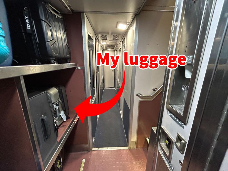 An arrow pointing to the author's luggage on a rack in an Amtrak train.