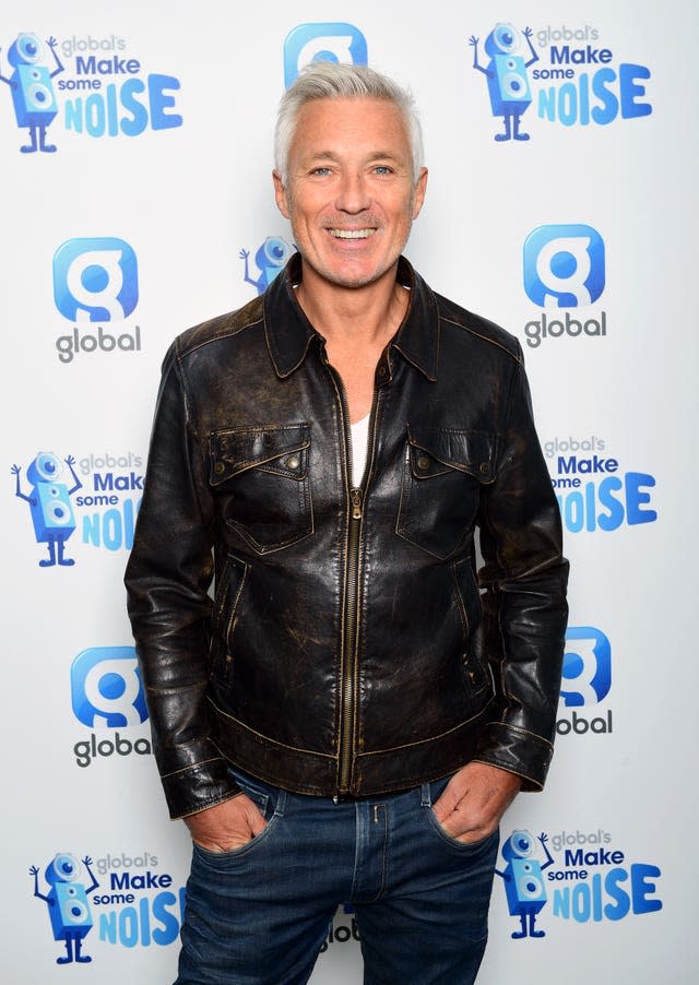 Martin Kemp smiling, with his hands in his pockets.