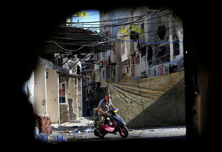 A man rides on a motorbike inside the Ain el-Hilweh refugee camp near Sidon, southern Lebanon, August 23, 2017. REUTERS/Ali Hashisho