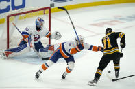 New York Islanders defenseman Nick Leddy, center, cannot stop Boston Bruins left wing Taylor Hall, right, from shooting his winning goal against Islanders goaltender Ilya Sorokin, left, in the overtime period of an NHL hockey game, Monday, May 10, 2021, in Boston. (AP Photo/Elise Amendola)