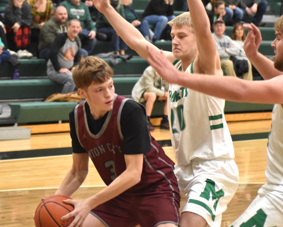 Union City's Landon Galvin (3) looks for an open teammate Friday night while Mendon's Owen Gorham defends