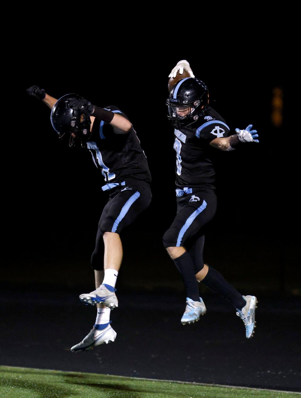 Lansing Catholic's Braden Rabideau, right, and Ty Rakan celebrate Rabideau's touchdown against Pewamo-Westphalia, Friday, Oct. 21, 2022, in Lansing. Lansing Catholic won 42-7.