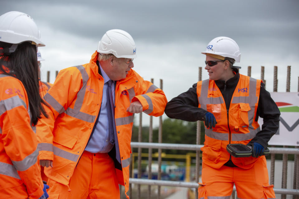 Prime Minister Boris Johnson (centre left) greets a worker during a visit to the HS2 Solihull Interchange building site in the West Midlands to mark the formal start of construction on HS2.