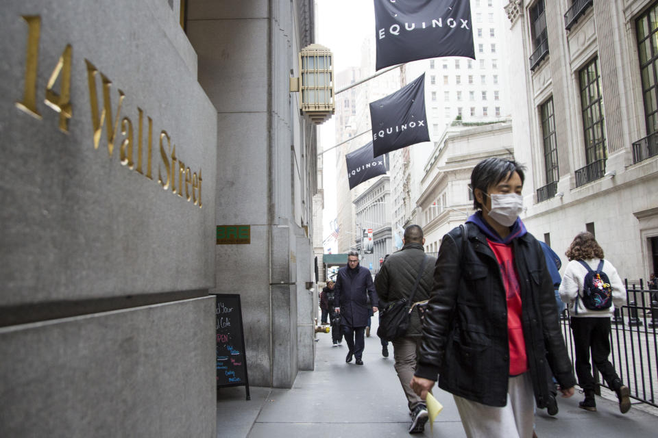 NEW YORK, NY - MARCH 12: A woman wearing a protective mask walks past the New York Stock Exchange on  March 12, 2020. in New York City. The Dow Jones industrial average fell 2,352.60 points, a decrease of almost 10% and the largest since 1987. (Photo by Pablo Monsalve/VIEWpress/Corbis via Getty Images)