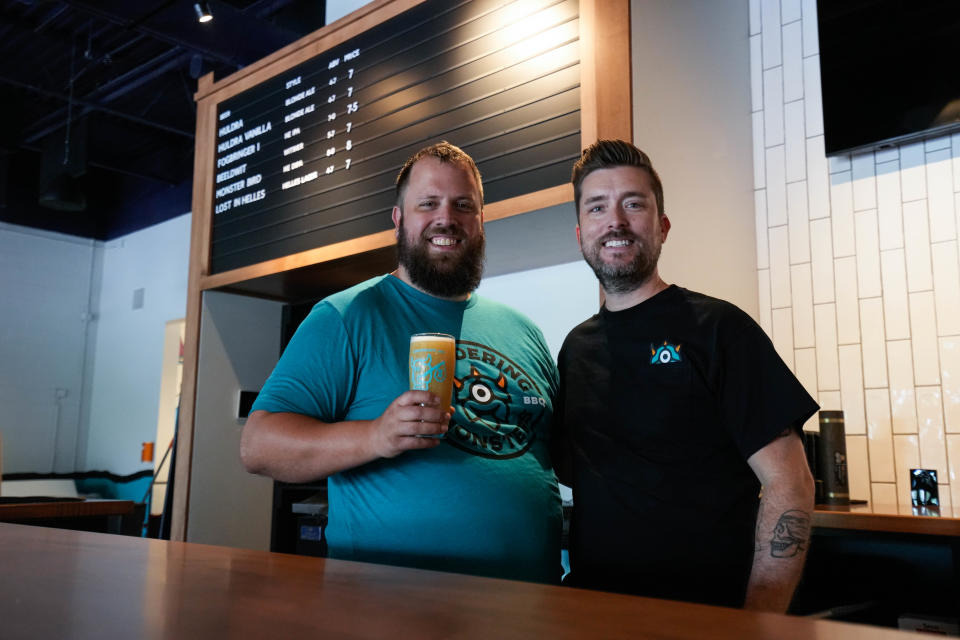 Wandering Monsters Brewery is opening in Anderson Township. The brewery features beer, a kitchen, outdoor patio and duckpin bowling. Owners Jason Brewer (left) and Mark Farris stand behind the bar.