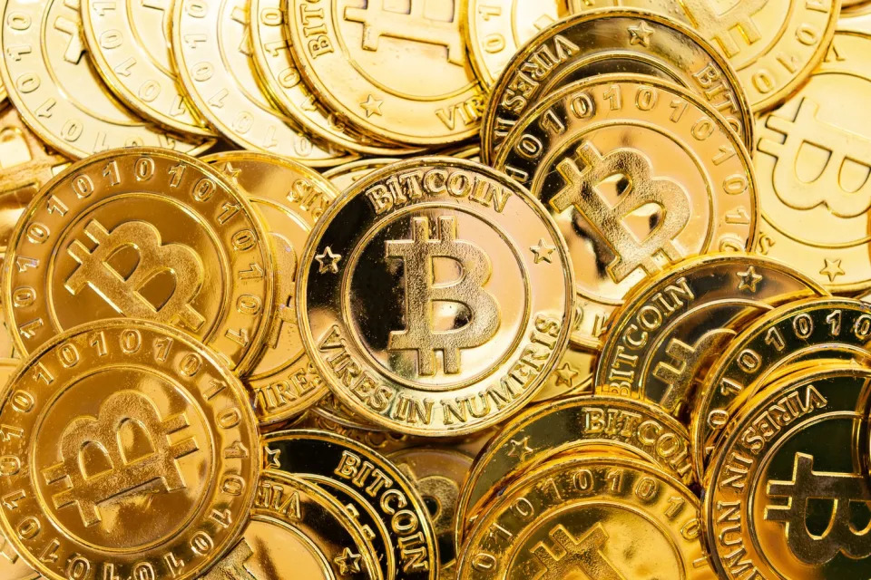 Gold coins with the Bitcoin logo.