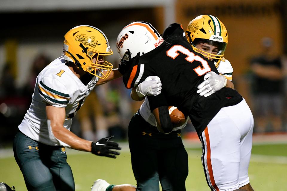 Blackhawk's Sam Stewart and Brendan Rodriguez tackle Beaver Falls Da'Talian Beauford during Friday's Week 0 game at Reeves Field at Geneva College.