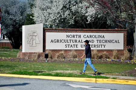 A student walks past the school sign at North Carolina A&T University in Greensboro, North Carolina, U.S. March 14, 2019. Picture taken March 14, 2019. REUTERS/Charles Mostoller