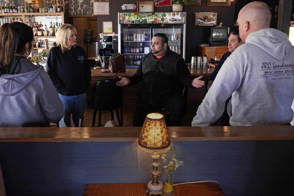 Steven Costa, center, owner and chef at Rosa's Tavern, gathers with other local business owners impacted by the closing of the Washington Bridge, due to failure of some bridge components, Friday, March 8, 2024, in East Providence, R.I. The closure of a section of the bridge, and onramps, has caused a significant loss to the group's revenue. (AP Photo/Charles Krupa)
