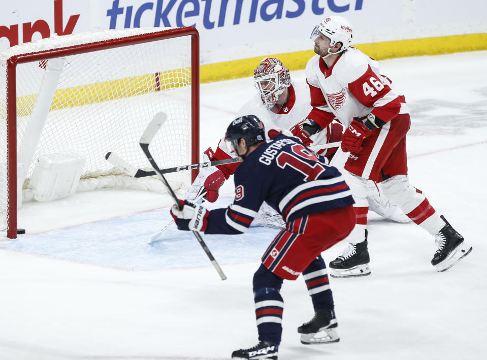 Winnipeg Jets' David Gustafsson (19) celebrates a goal against Detroit Red Wings goaltender James Reimer (47), while Jeff Petry (46) reacts during the first period of an NHL hockey game Wednesday, Dec. 20, 2023, in Winnipeg, Manitoba. (John Woods/The Canadian Press via AP)