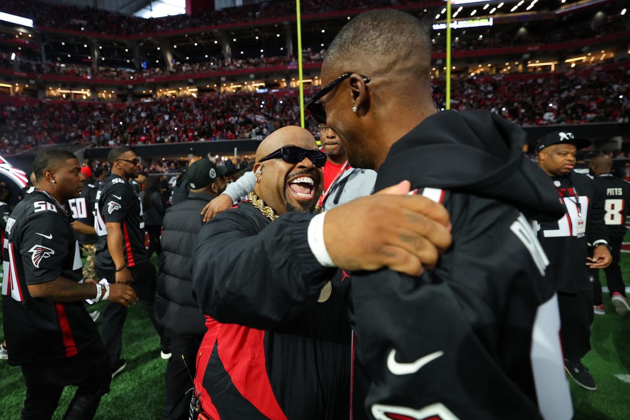 ATLANTA, GEORGIA - NOVEMBER 26: CeeLo Green (L) greets Rico Wade (R) before the game between the New Orleans Saints and Atlanta Falcons at Mercedes-Benz Stadium on November 26, 2023 in Atlanta, Georgia. (Photo by Kevin C. Cox/Getty Images)