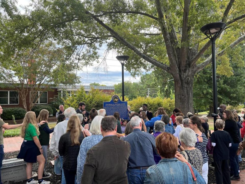 Community members pray together to honor victims of lynching in Chatham County at reveal of new historical marker.