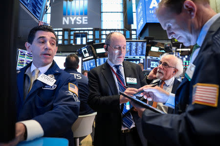 FILE PHOTO: Traders work on the floor at the New York Stock Exchange (NYSE) in New York, U.S., April 9, 2019. REUTERS/Brendan McDermid