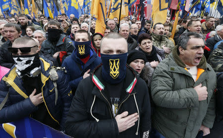 Activists of nationalist groups and their supporters take part in the so-called March of Dignity, marking the third anniversary of the 2014 Ukrainian pro-European Union mass protests, in Kiev, Ukraine. REUTERS/Valentyn Ogirenko