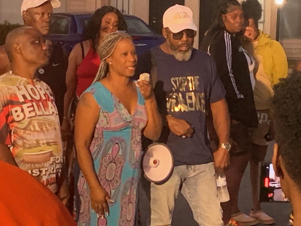 Mother Tuwanan Ware, center, speaks at a vigil for her son, Dereck Cummings, better known in the community as Antwaun Miles.