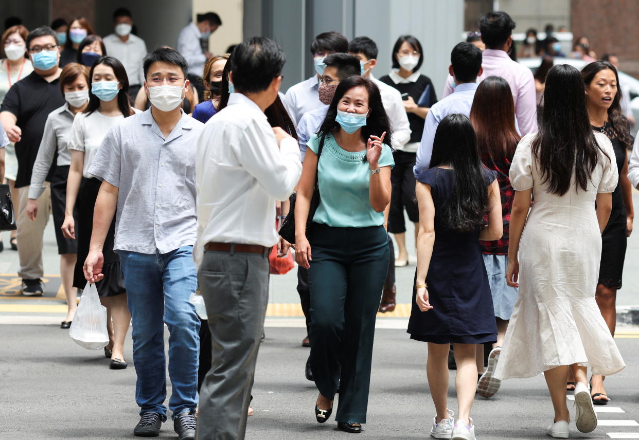 Office workers go for lunch at the central business district on the first day free of coronavirus disease (COVID-19) restrictions in Singapore, April 26, 2022. REUTERS/Edgar Su