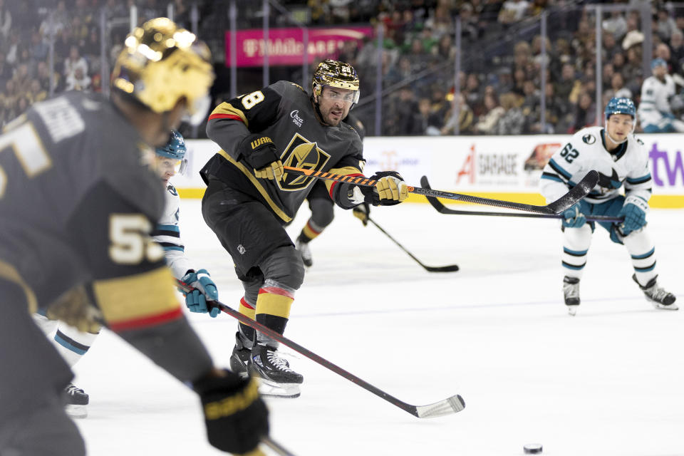 Vegas Golden Knights left wing William Carrier (28) passes the puck to right wing Keegan Kolesar, left, during the second period of an NHL hockey game against the San Jose Sharks, Sunday, Dec. 10, 2023, in Las Vegas. (AP Photo/Ellen Schmidt)