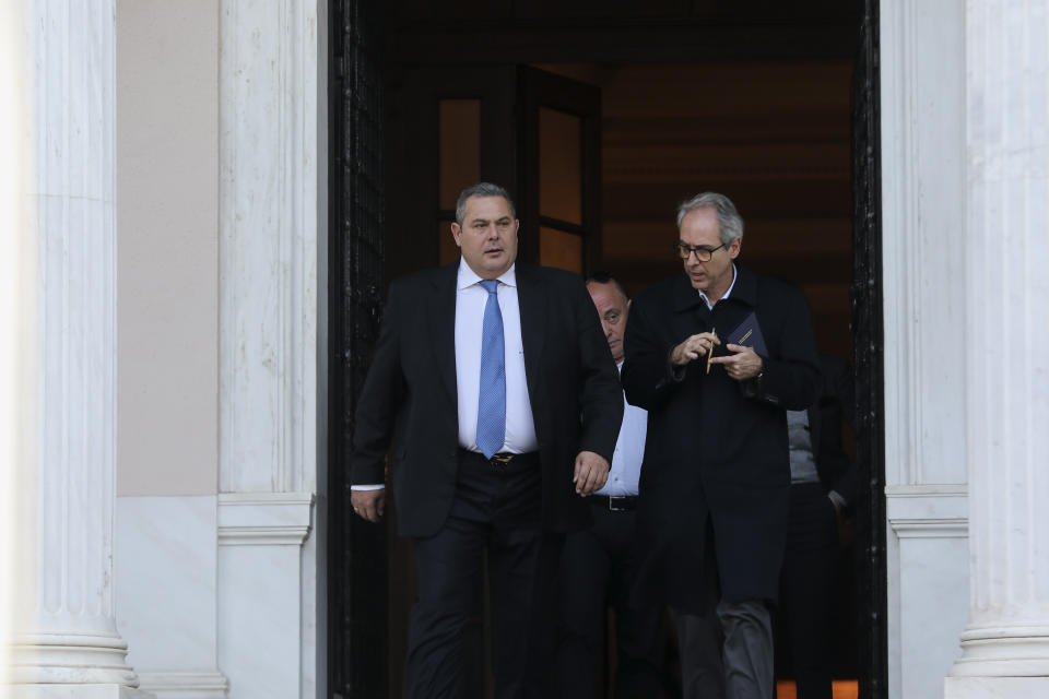 Greek Defense Minister Panos Kammenos, left, leaves Maximos mansion following a meeting with Greece's Prime Minister Alexis Tsipras, in Athens, Sunday, Jan. 13, 2019. Greek defense Minister Kammenos, leader of the right-wing populist Independent Greeks party, is vehemently opposed to a deal with neighboring Macedonia over its state name. (AP Photo/Yorgos Karahalis)