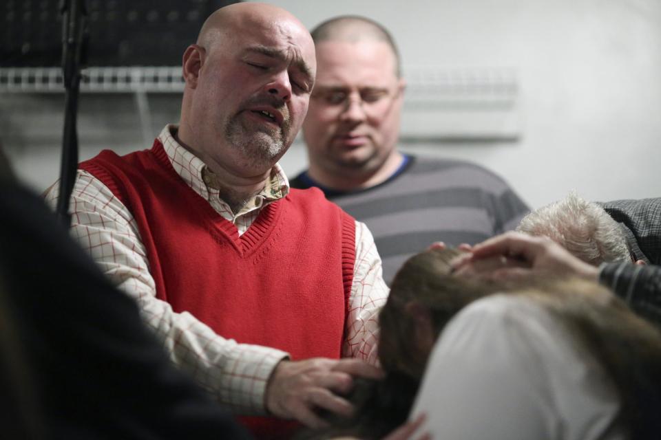 FILE - In this Dec. 11, 2013 file photo, Pastor Jamie Coots prays during a service at the Full Gospel Tabernacle In Jesus Name church in Middlesboro, Ky. Coots died Sunday, Feb. 16, 2014, after being bitten by a rattlesnake. (AP Photo/Chattanooga Times Free Press, Dan Henry)