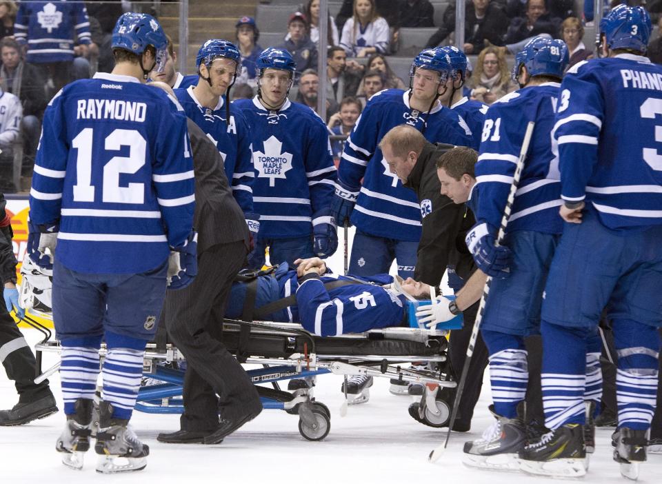 Toronto Maple Leafs' Paul Ranger is taken off the ice on a stretcher after hitting the boards head first from a check by Tampa Bay Lightning's Alex Killorn during first period NHL action in Toronto on Wednesday March 19, 2014. (AP Photo/The Canadian Press, Frank Gunn)