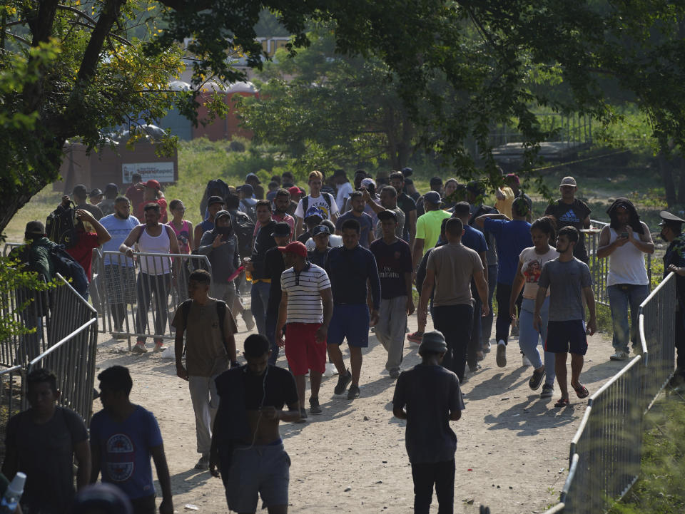 Migrants, mostly from Venezuela, arrive at a camp where Mexican authorities will arrange permits for their continued travel north, in San Pedro Tapanatepec, Oaxaca, Mexico Wednesday, Oct. 5, 2022. As migrants, especially Venezuelans, struggle to come to terms with a new U.S. policy discouraging border crossings, the town of San Pedro Tapanatepec is unexpectedly playing host to over 10,000 migrants camped far from the U.S. border. (AP Photo/Marco Ugarte)