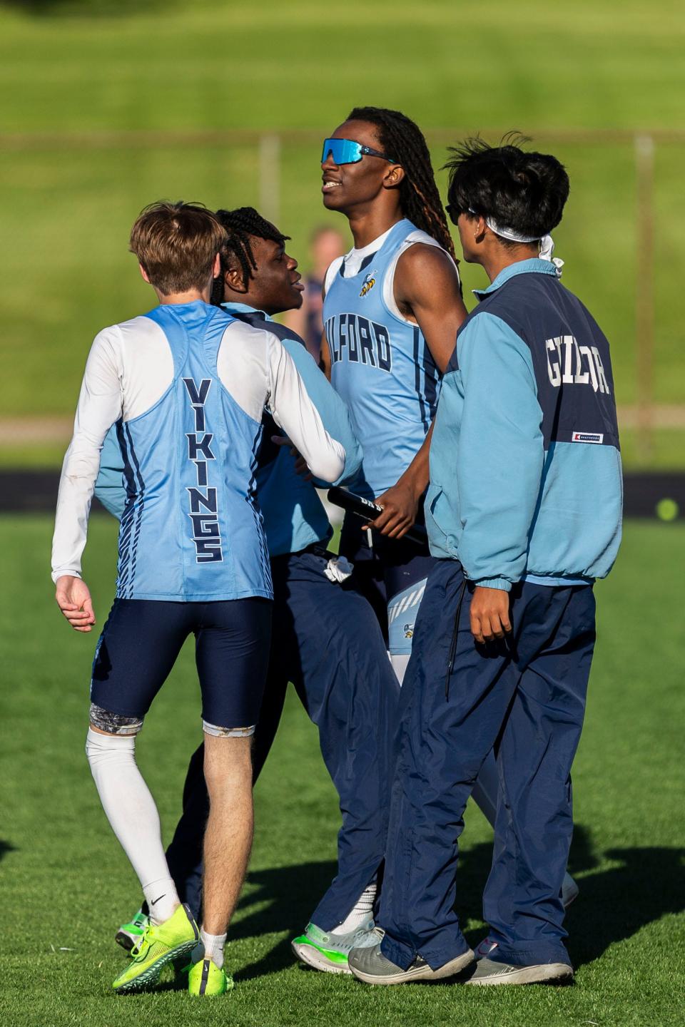 Guilford sprinter Messiah Tilson is congratulated by teammates after winning the 4x100 relay at the boys NIC-10 conference meet on Friday, May 10, 2024, at Auburn High School.