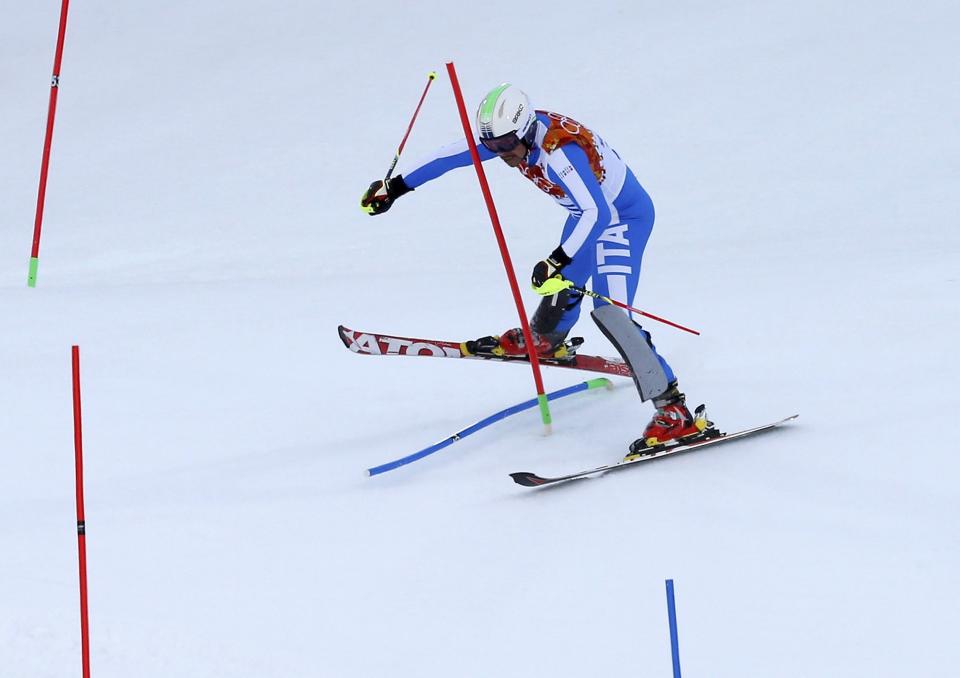 Italy's Peter Fill straddles a gate during the slalom run of the men's alpine skiing super combined event during the 2014 Sochi Winter Olympics at the Rosa Khutor Alpine Center in Rosa Khutor February 14, 2014. REUTERS/Mike Segar (RUSSIA - Tags: OLYMPICS SPORT SKIING)