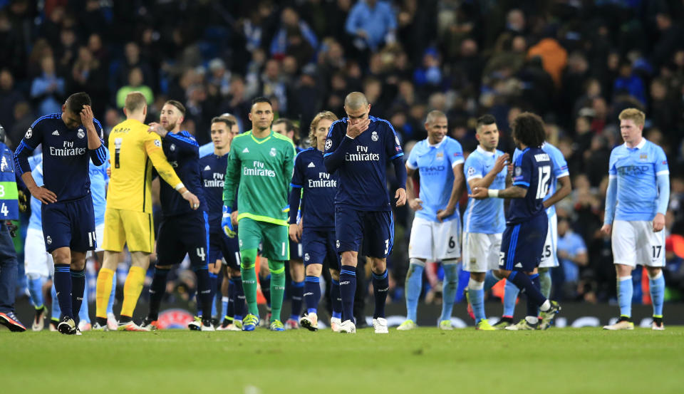 Real Madrid and Manchester City players leave the pitch at the end of the Champions League semifinal soccer match between Manchester City and Real Madrid, at the City of Manchester stadium in Manchester, England, Tuesday, April 26, 2016. (AP Photo/Jon Super)