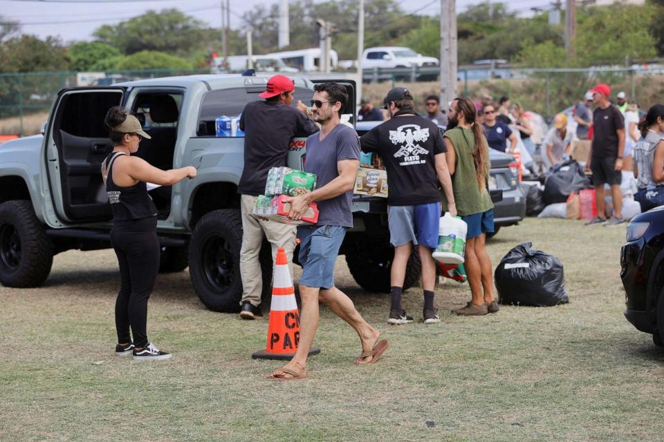 PHOTO: Maui residents drop off supplies for the West Maui wildfire evacuees at a shelter set up at the Maui War Memorial in Wailuku, Hawaii, Aug. 10, 2023. (Marco Garcia/Reuters)