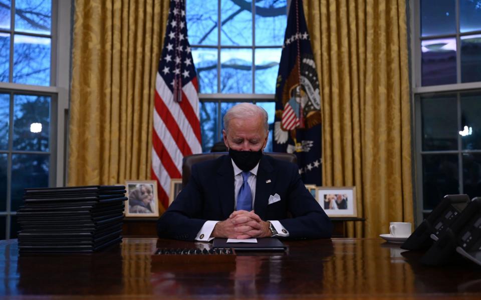 US President Joe Biden signed a raft of executive orders to launch his administration, including a decision to rejoin the Paris climate accord - Jim Watson/AFP