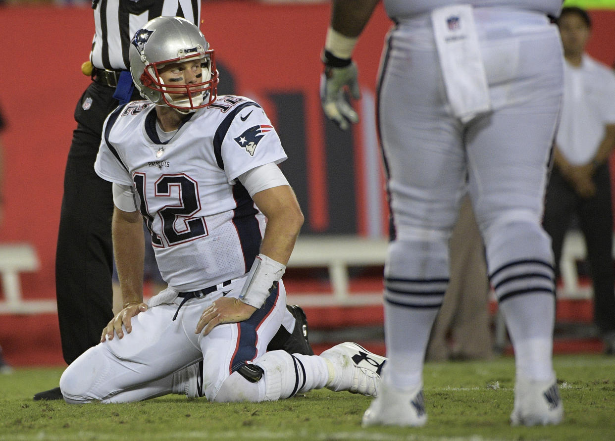 Tom Brady weathered the hits from the Bucs and led the Patriots to a 19-14 victory on Thursday night. He was sacked three times, bringing the season total to 16. (AP)