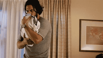 Jack from "This Is Us" rocking a newborn.